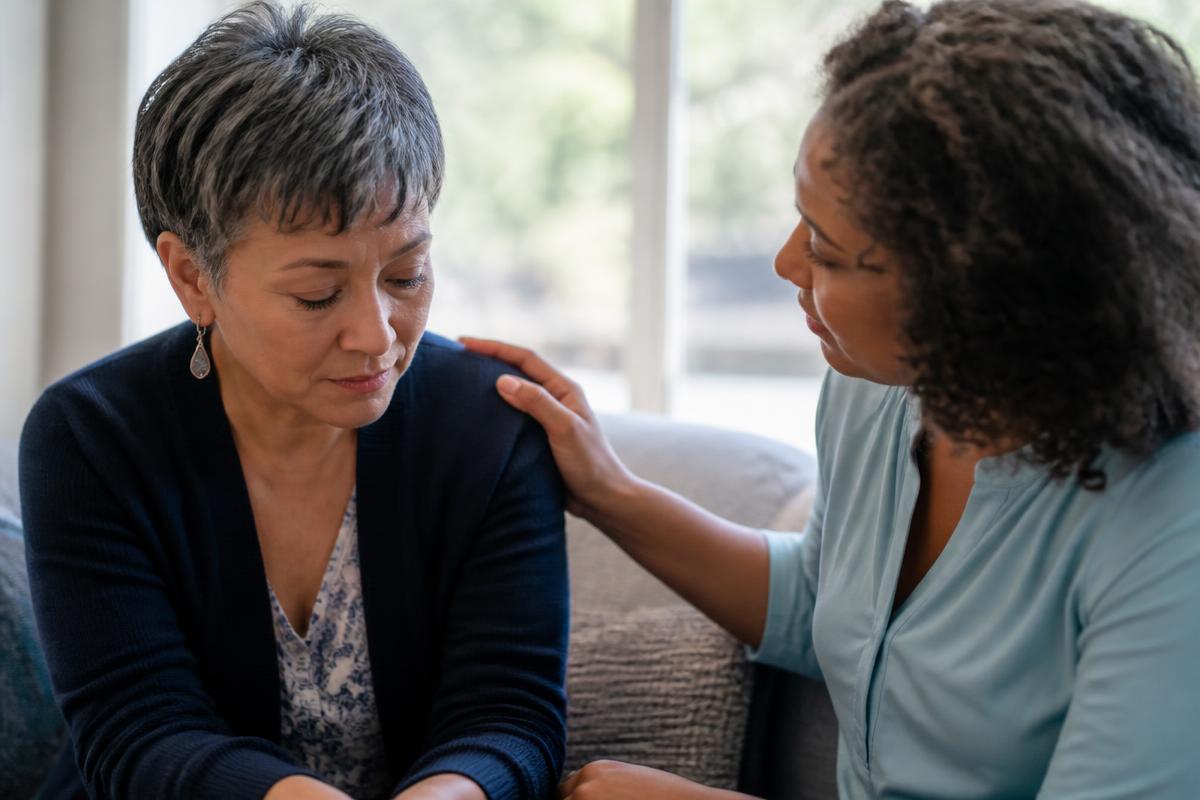 A grieving person receiving compassionate support